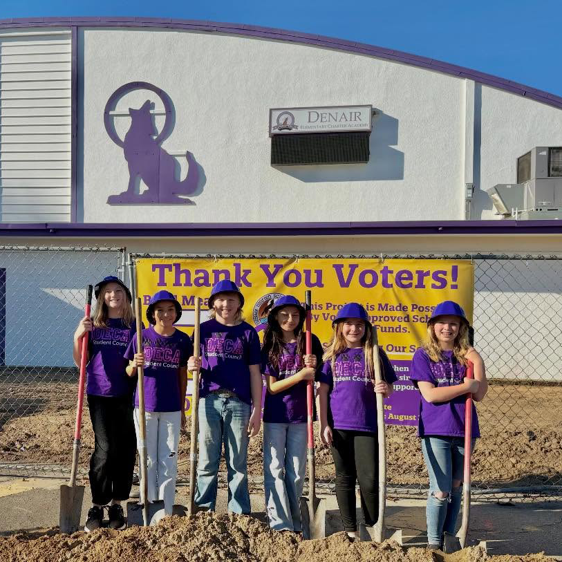 students standing in front of sign "thank you voters"